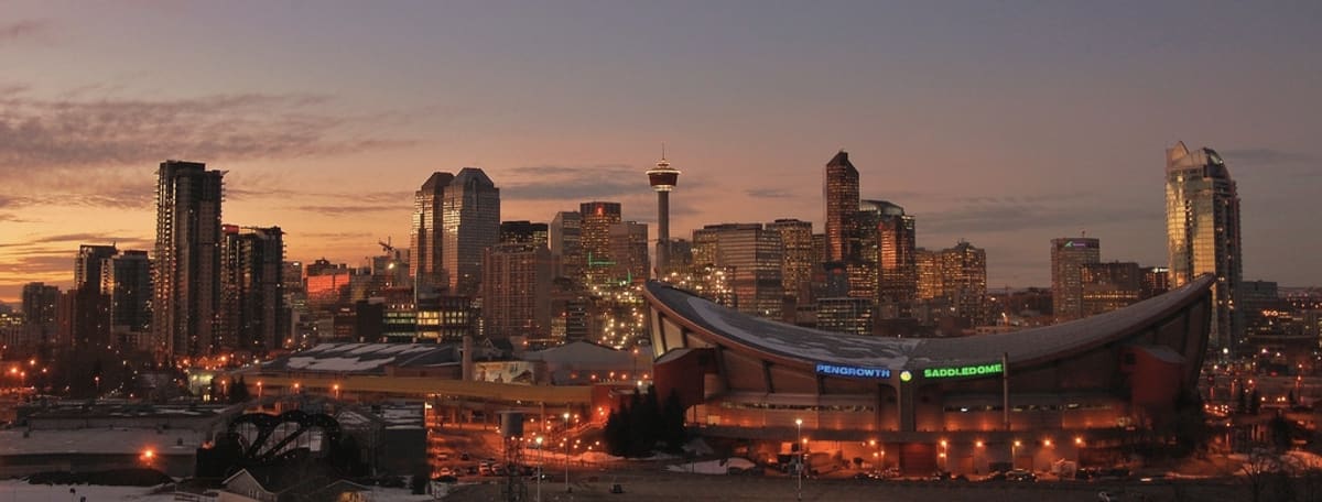 Calgary downtown towers at dusk, where many owner-managed Alberta businesses are bought and sold