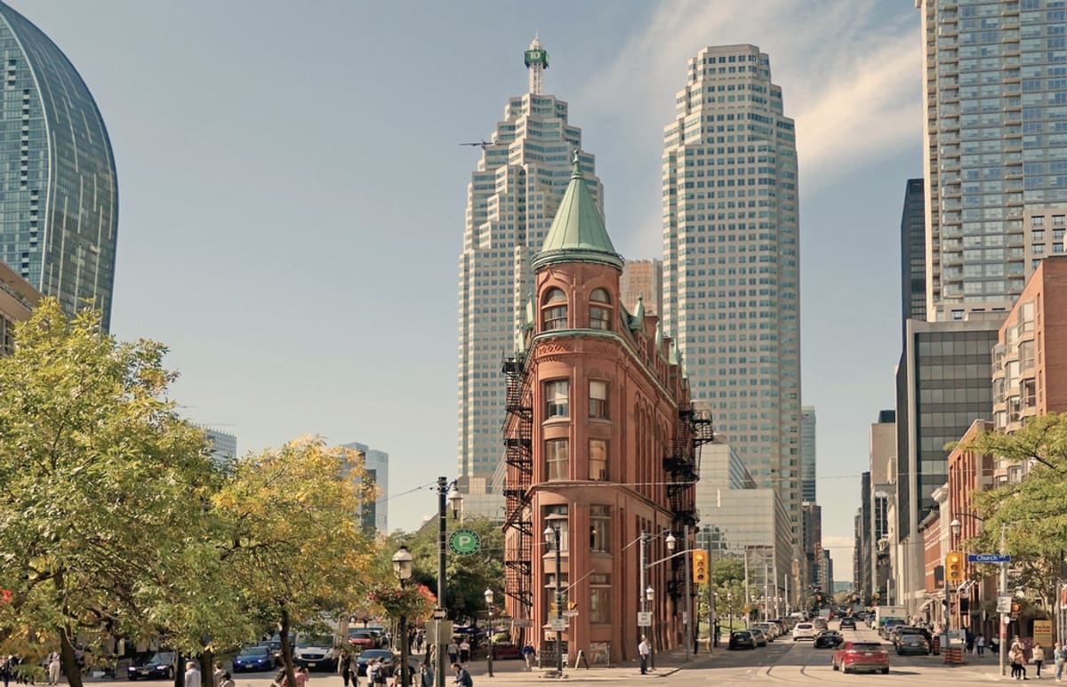 Busy downtown Toronto street with office towers and a streetcar
